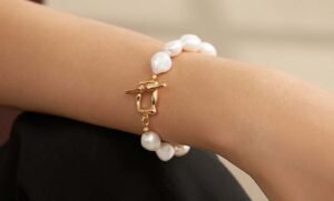 Baroque pearl bracelets with white irregular, non-spherical pearls and a gold clasp, reflecting wild curves, ridges, and quirky textures for jewelry.