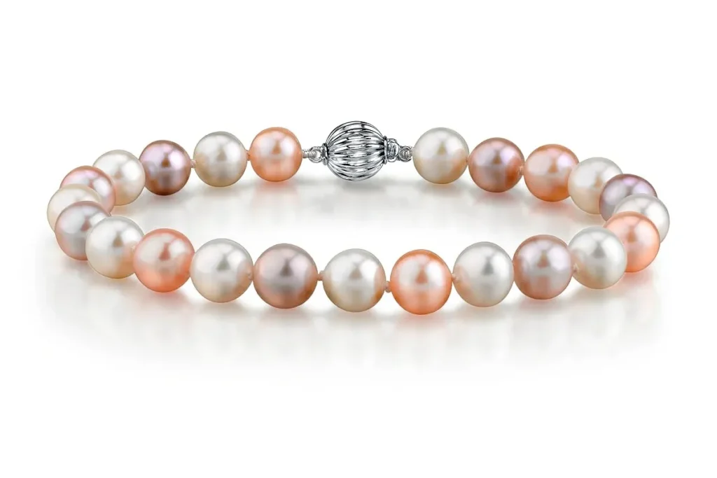 Bracelet made of multi-colored pearls in shades of pink, white, and lavender with a silver clasp.