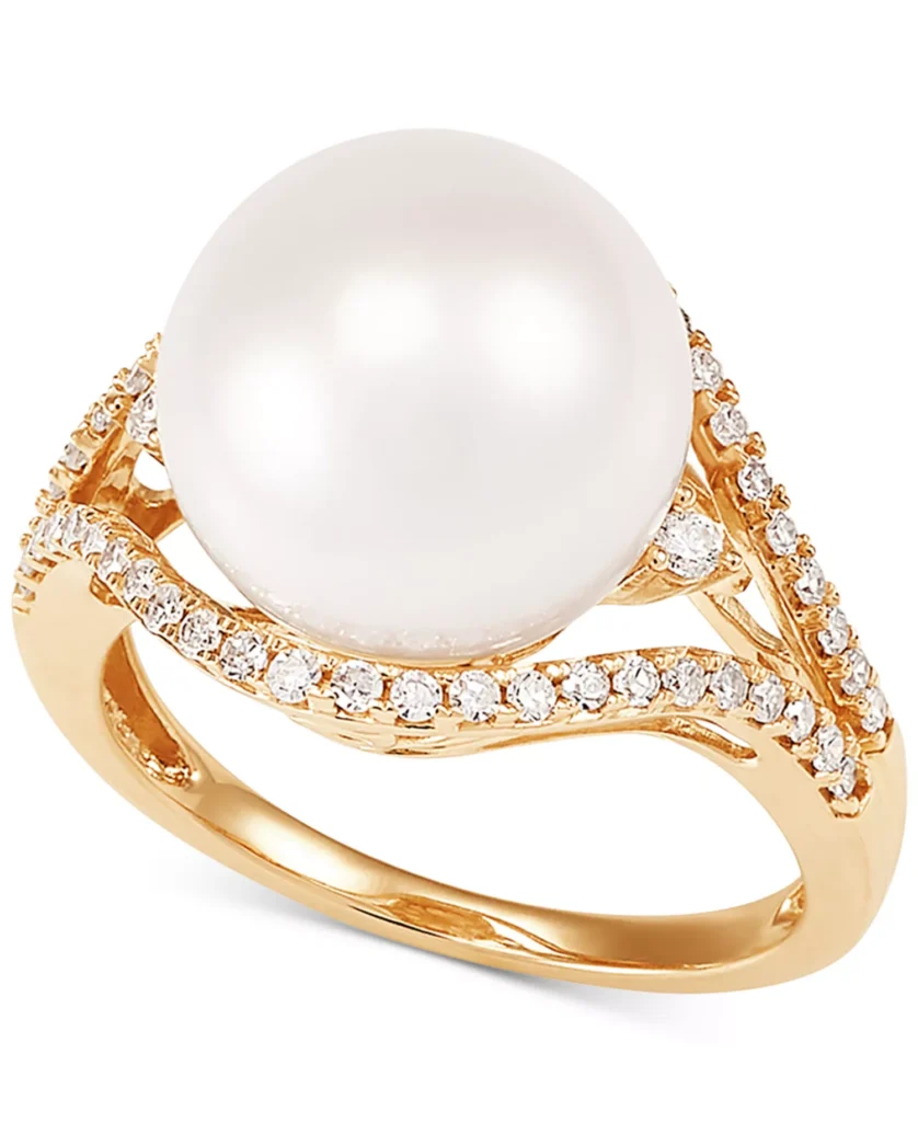 Gold ring featuring a large white pearl surrounded by small diamond accents on a decorative band.