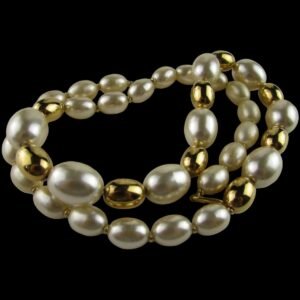 Faux pearl necklace with gold-tone beads, featuring a mix of oval and round shapes in a classic design.