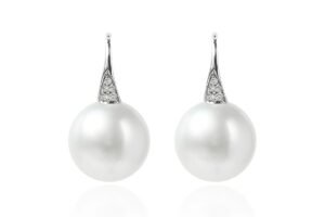 White dainty dew pearl earrings with a silver setting and small diamond accents, showcasing a classic and elegant design.