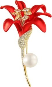 Red rose flower brooch with gold accents and a pearl detail, adorned with sparkling gemstones.