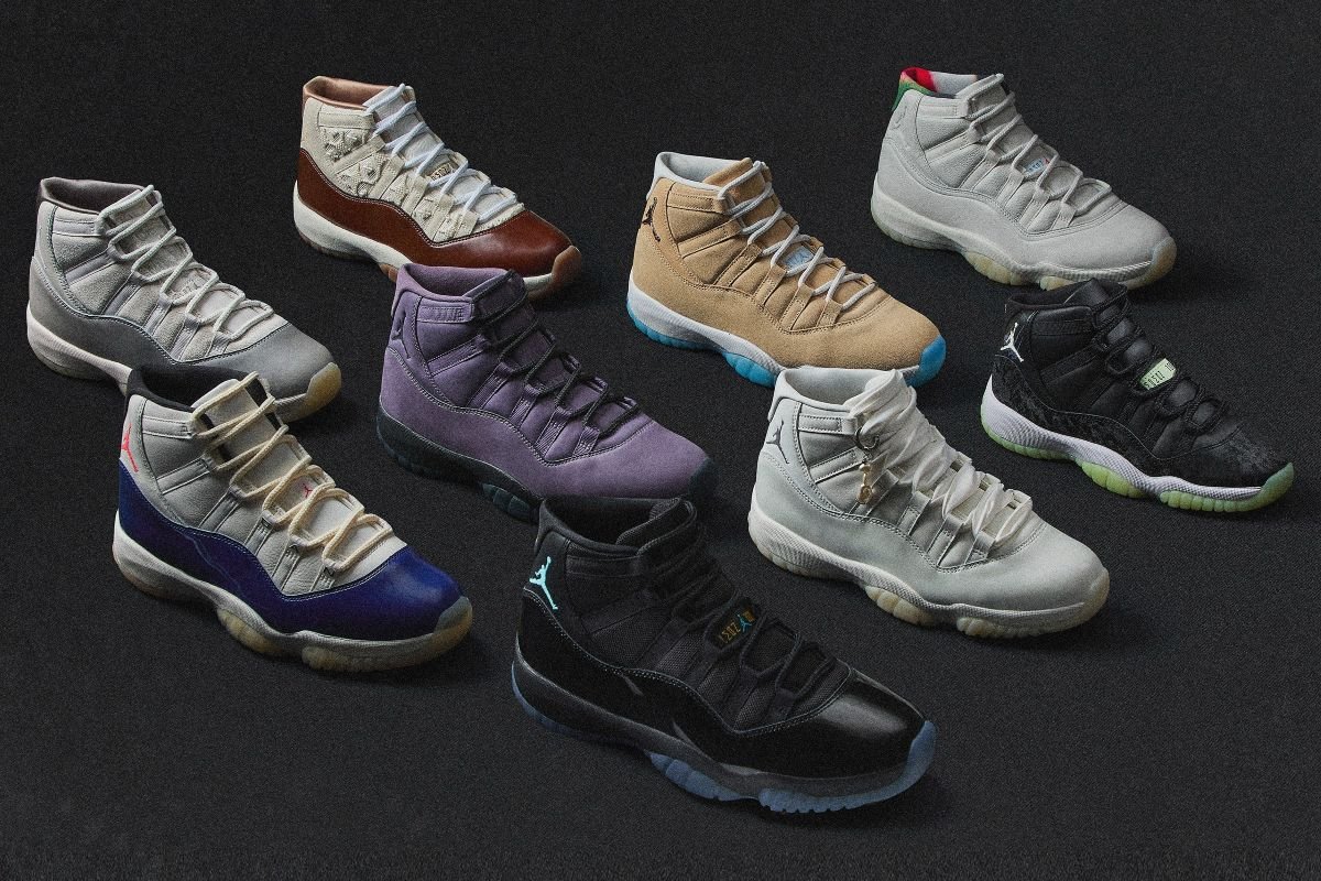 Pearl-white and dark Air Jordan 11 sneakers from Nike, arranged as multiple pearl-inspired colorways on a matte black studio backdrop with subtle iridescent shimmer details.