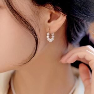 Pearl hoop earrings with lustrous simulated shell pearls and warm 14K gold plating form a modern hoop that brings classic-chic style.